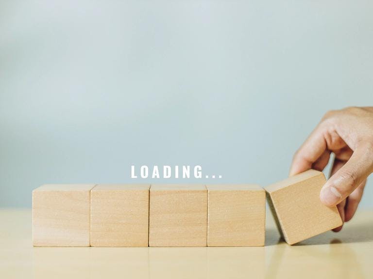 five wooden blocks in a line with the word loading above